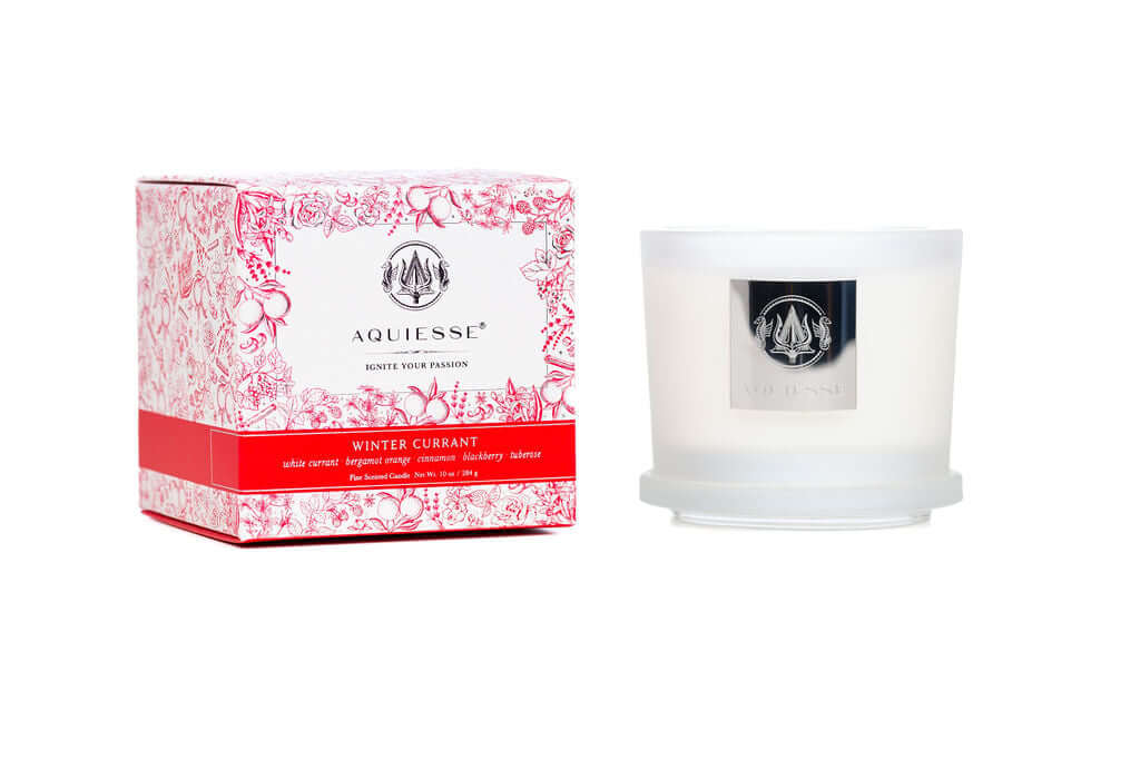 Aquiesse Winter Currant candle in a frosted glass container with floral packaging.