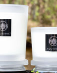 Aquiesse Winter Currant Candles in frosted glass jars with elegant branding, set against a natural background.