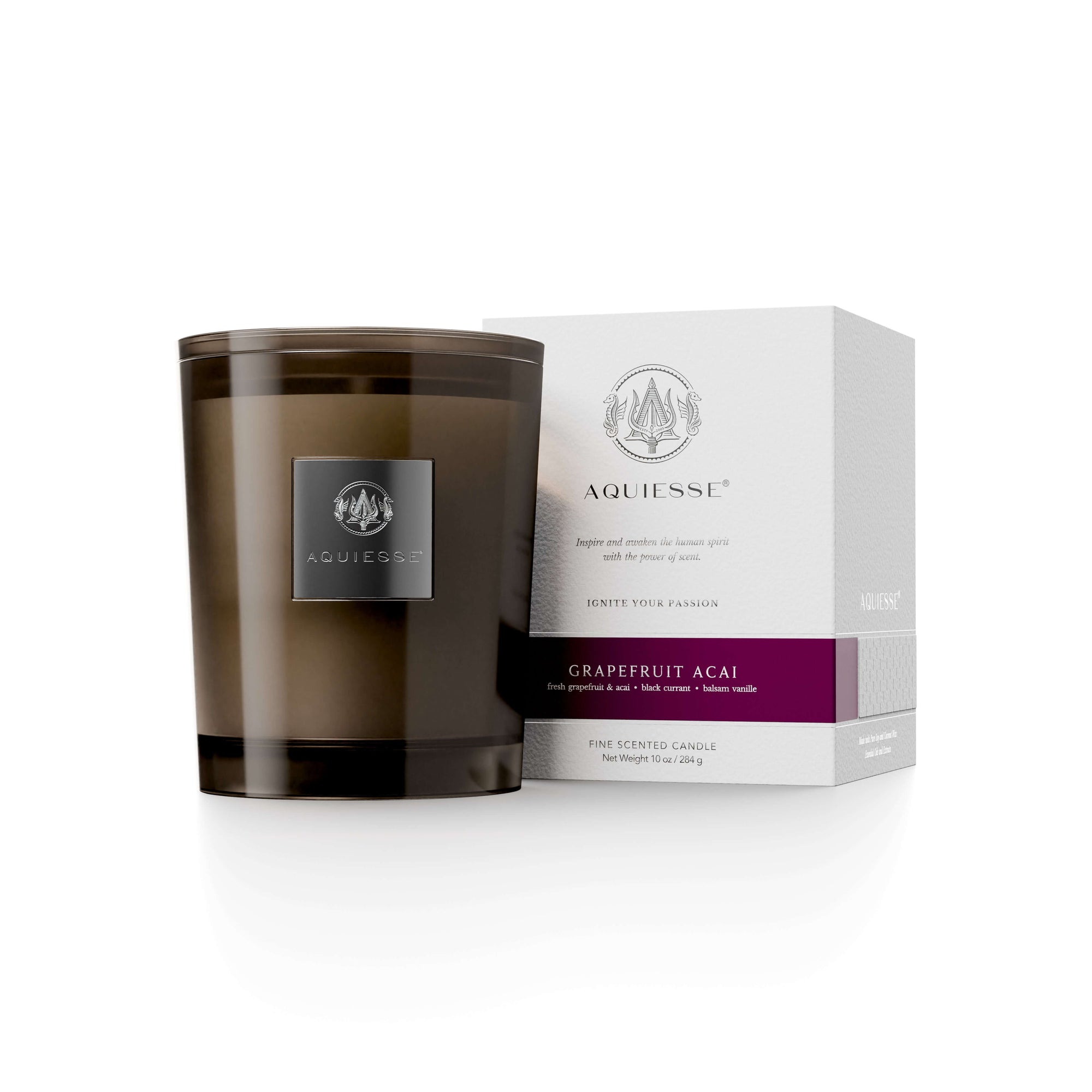 Grapefruit Acai candle in brown glass jar with white box, featuring fresh grapefruit, acai berry, and balsam vanilla scent.