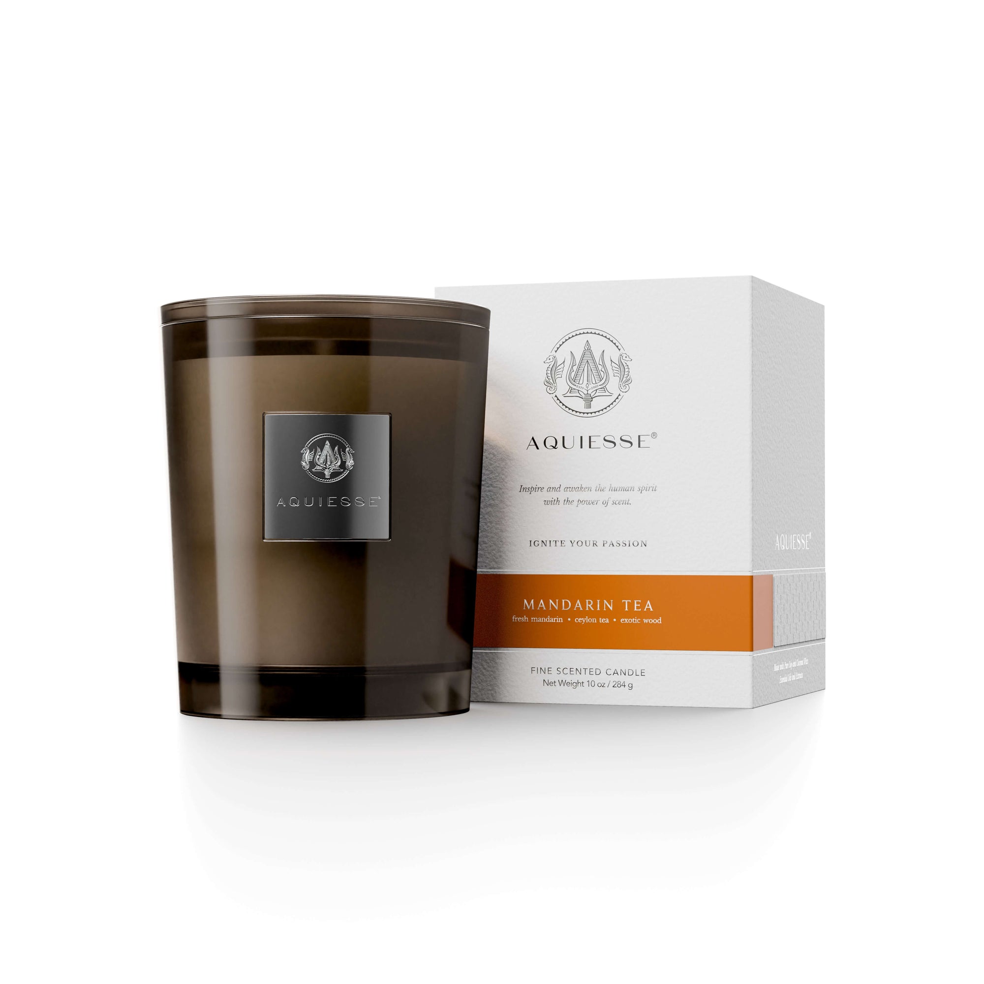 Mandarin Tea candle by Aquiesse in a brown glass container, accompanied by an elegant packaging box.